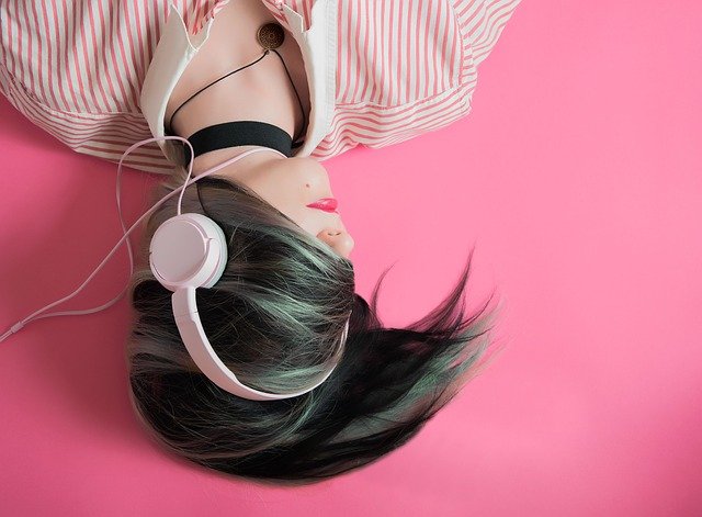 girl listening to music via headphones